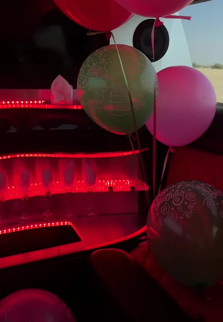 Limousine decorated with balloons and Happy Birthday banners